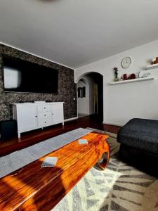 a living room with a wooden coffee table and a television at Vintage house for rent in Klaukkala