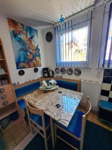 a dining room with a table and blue chairs at Ferienwohnung galina in Rockenhausen