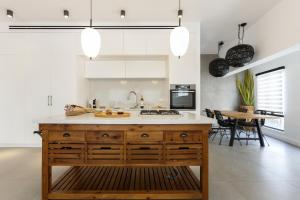 a kitchen with a wooden island in the middle at AirTLV - Bazel Central Apartment With Balcony in Tel Aviv
