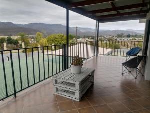 a balcony with a table and a view of a pool at The Little Gem in Clanwilliam