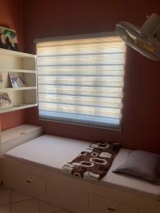 a small room with a bed with a window at 3BR 70sqm Free internet, Penthouse unit in Ermita, Manila near US Embassy in Manila +13 photos