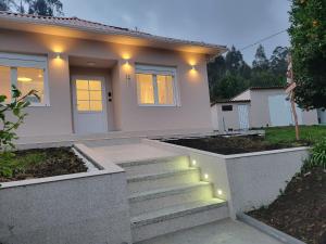 a house with stairs in front of it with lights at CASA DE NUNA in Cabana de Bergantiños
