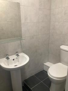 a bathroom with a white toilet and a sink at The New Apollo Hotel in Blackpool