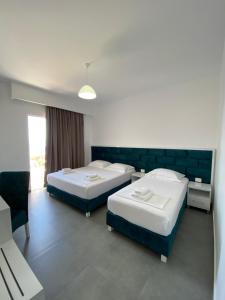 um quarto de hotel com duas camas e uma janela em Eraldo's Rooms and Apartments em Sarandë