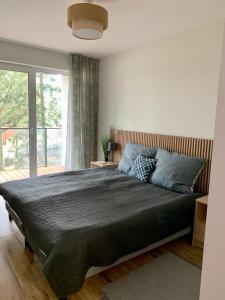 a bedroom with a large bed and a window at Luna in Dziwnów