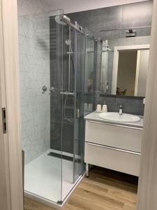 a bathroom with a shower and a sink at Luna in Dziwnów