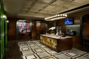 a lobby with a counter with bottles of wine at UrCove by HYATT Hangzhou West Lake - Ten minutes walk to the West Lake in Hangzhou