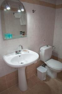 a bathroom with a white sink and a toilet at Phyllida Guest House - A2 in Zacharo