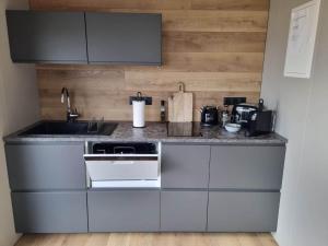 a kitchen with a sink and a stove top oven at New and well furnished studio apartment for two 30 km from Kirkjubæjarklaustur Perfect place to stay at right between Black beach and Jökulsárlón in Kirkjubæjarklaustur