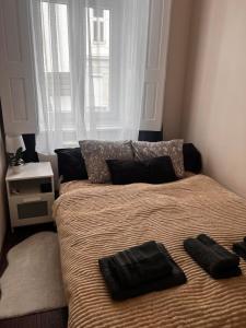 Una cama con dos almohadas encima en un dormitorio. en VM56, en Budapest