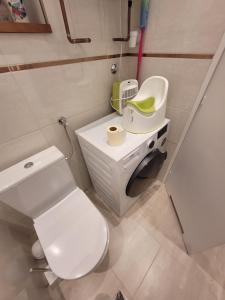 La salle de bains est pourvue de toilettes blanches et d'un lavabo. dans l'établissement VM56, à Budapest