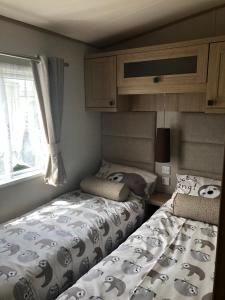 a bedroom with two beds and a window at The Sherbourne in Selsey