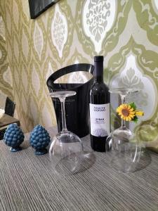uma garrafa de vinho e dois copos numa mesa em Casa vacanza da Giuseppe em Leonforte