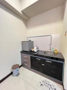 a kitchen with a sink and a counter top at Homestay Bayou Lagoon Ayer Keroh Melaka by AlliEyka in Melaka