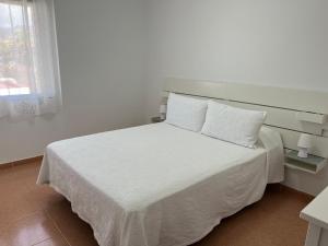 En eller flere senger på et rom på Apartamento Cristina 2I