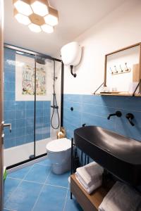 uma casa de banho azul com um lavatório e um WC em Casina Lambis em Pozzuoli