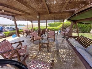 a group of chairs and tables on a patio at فيلا مارينا٥ على البحيره ٥ غرف in El Alamein