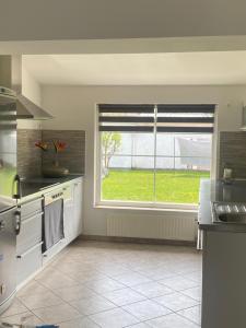 a kitchen with a window and a sink and a stove at Apartman Slivnica pri Mariboru in Slivnica pri Mariboru