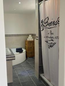 a bathroom with a tub and a shower curtain at Apartman Slivnica pri Mariboru in Slivnica pri Mariboru