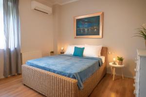 a bedroom with a bed with a blue blanket at Deja Blue Chania in Daratso
