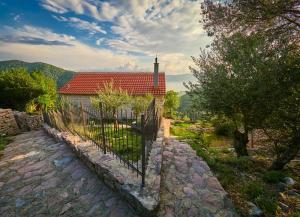 a church with a fence in front of a building at Villa Look in Tivat