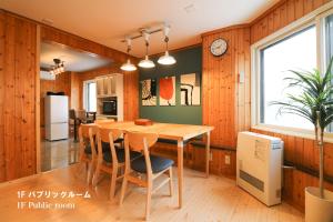 a kitchen and dining room with a table and chairs at Culture24 in Sapporo