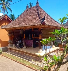 a house with a drum set in front of it at Rindu Homestay in Undisan