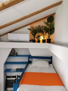 a small bed in a small room with plants at Apartment Camerin in Koper