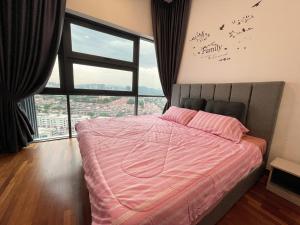 a bedroom with a pink bed with a large window at Pacific Tower Petaling Jaya Near Jaya One, University Malaya, Columbia Hospital By My Homez in Petaling Jaya