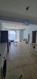 a large living room with a view of the ocean at Summer Breeze Apartment Saranda in Sarandë