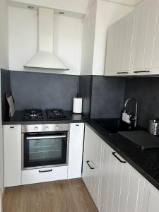 a kitchen with white cabinets and a stove at La Couronne Appartement a Nice in Nice