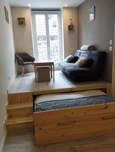 uma sala de estar com um sofá e uma mesa em House of twenty, calme,rue piétonne, proche de la mer, wifi gratuit em Dieppe