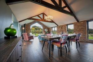 a dining room with a table and some chairs at Woodland Barn in Durham