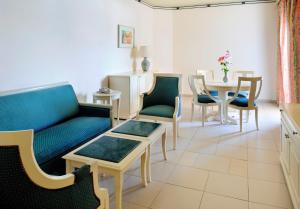 a living room with a couch and chairs and a table at Naama Bay Promenade Beach Resort Managed By Accor in Sharm El Sheikh