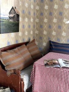 a bedroom with a bed and a table with a book at Husmannsplassen Havrebakken på Helgøya in Ringsaker