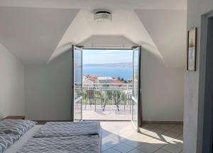 a bedroom with a view of the ocean at Apartment Anic in Karlobag