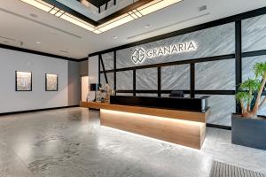 a lobby with a grandania sign on the wall at Granaria by Welcome Apartment in Gdańsk