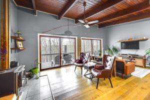 a living room with chairs and a table and a television at Private Delevan Cabin Rental Lake Access with Dock! 