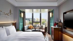 a hotel room with a bed and a tv at UrCove by HYATT Hangzhou West Lake - Ten minutes walk to the West Lake in Hangzhou