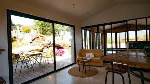 a living room with a table and chairs and a patio at A Camerina in Sotta