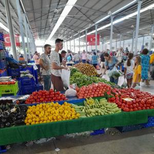 een markt met een groot aanbod van groenten en fruit bij Dikili in Dikili