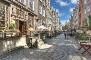 a cobblestone street in a city with buildings at Granaria by Welcome Apartment in Gdańsk