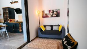a living room with a blue couch with pillows at villa rocca in Sotta