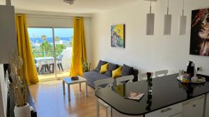 a living room with a couch and a table at El Sueño Ocean Lanzamar - Puerto Del Carmen in Puerto del Carmen