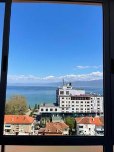 a view of a large building from a window at City Center With Lake View One Bedroom Apartment in Pogradec