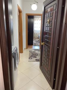 a hallway with a door leading to a laundry room at City Center With Lake View One Bedroom Apartment in Pogradec