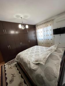 a bedroom with a bed and a chandelier at City Center With Lake View One Bedroom Apartment in Pogradec
