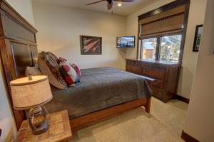 a bedroom with a bed and a dresser and a window at River Run Townhomes 63 in Keystone