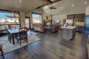 a large kitchen and living room with a table and chairs at River Run Townhomes 63 in Keystone