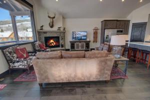 a living room with a couch and a fireplace at River Run Townhomes 63 in Keystone